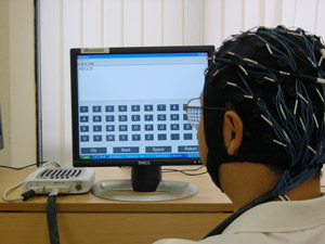 Fig. 1: A person spelling words using only brain waves via an EEG-based brain computer interface.