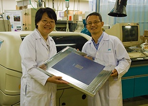 Jie Zhang (left) and Zhikuan Chen (right) hold a printed electronic device