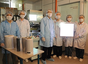 Albert Lu (fourth from right) and colleagues with printed lighting and printed functional film samples