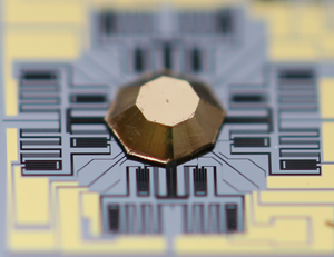 A polygon-shaped pyramidal reflector on a silicon microelectromechanical system (MEMS) chip that allows full circumferential diagnostic imaging.