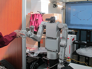A role adaptation control scheme allows the leader or follower role of a robot to be adjusted continuously based on the sensed intention of a human collaborator.